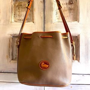 Dooney $ Bourke beige drawstring bag. 10 inches high/13 wide/6 inches deep